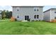 A home's backyard featuring a well-maintained lawn, patio, and exterior view of the house at 2010 Moonlight Path, Covington, GA 30016