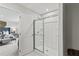 Close-up of a shower stall featuring a glass door and built in shelves located within the bathroom at 2010 Moonlight Path, Covington, GA 30016