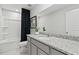 Well-lit bathroom featuring a granite vanity top, ample storage, and a shower-tub combo at 2010 Moonlight Path, Covington, GA 30016