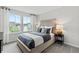 Beautifully staged bedroom with a plush bed, stylish lamps, and plenty of natural light from two windows at 2010 Moonlight Path, Covington, GA 30016