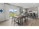 Open dining room featuring hardwood floors, modern table with seating, and a sliding glass door to the backyard at 2010 Moonlight Path, Covington, GA 30016