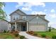 Charming two-story home featuring a welcoming front porch and well-manicured landscaping at 2010 Moonlight Path, Covington, GA 30016