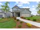 Beautiful home with a well-maintained lawn, complemented by a paved walkway and mulch flower beds at 2010 Moonlight Path, Covington, GA 30016