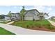 Landscaped front yard with a sidewalk leading up to a two-story home, under a clear sky at 2010 Moonlight Path, Covington, GA 30016