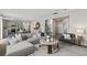 Spacious living room with a modern kitchen, stylish furniture, and hardwood floors at 2010 Moonlight Path, Covington, GA 30016
