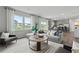 Open-concept living room with large windows, modern furniture, and a view of the neighborhood at 2010 Moonlight Path, Covington, GA 30016