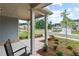 Cozy front porch with a rocking chair and manicured flower beds, providing a welcoming view at 2010 Moonlight Path, Covington, GA 30016