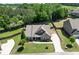 Aerial view of a home with lush landscaping, driveway, and a fenced backyard with a wooded border at 2906 Jones Phillips Rd, Dacula, GA 30019