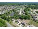 An aerial view captures houses nestled in a neighborhood featuring a pond and surrounding greenery at 2906 Jones Phillips Rd, Dacula, GA 30019