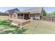 A multi-tiered deck leads to a screened in porch in this backyard with a privacy fence at 2906 Jones Phillips Rd, Dacula, GA 30019