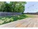 Spacious backyard with a wooden deck, a lush lawn, and decorative string lights for evening enjoyment at 2906 Jones Phillips Rd, Dacula, GA 30019