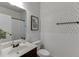 This bathroom boasts stylish wallpaper, a framed map of Georgia, a sleek sink, and a convenient towel rack at 2906 Jones Phillips Rd, Dacula, GA 30019