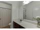 This bathroom is complete with a dark wood vanity, decorative flowers, and a large mirror and shower at 2906 Jones Phillips Rd, Dacula, GA 30019