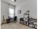 This carpeted bedroom with natural light features a functional desk, storage shelves, and decorative guitars at 2906 Jones Phillips Rd, Dacula, GA 30019