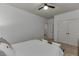 This carpeted bedroom features a comfortable bed with white linens and a ceiling fan at 2906 Jones Phillips Rd, Dacula, GA 30019