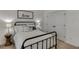 A well-lit bedroom featuring a comfortable bed, matching lamps, a decorative sign, and a convenient closet at 2906 Jones Phillips Rd, Dacula, GA 30019