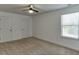 This bedroom features a ceiling fan, carpet, and natural light from the window at 2906 Jones Phillips Rd, Dacula, GA 30019
