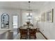 Bright dining area with a modern light fixture and doorway to living area at 2906 Jones Phillips Rd, Dacula, GA 30019