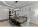 Elegant dining room with a decorative chandelier and modern decor with access to other rooms at 2906 Jones Phillips Rd, Dacula, GA 30019