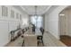 Dining room with a tray ceiling, wainscoting, and a long wooden table for entertaining at 2906 Jones Phillips Rd, Dacula, GA 30019