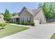 View of the home's exterior, with a long driveway leading to the attached garage at 2906 Jones Phillips Rd, Dacula, GA 30019