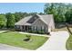 Charming home featuring a well-manicured lawn, inviting front porch, and long driveway at 2906 Jones Phillips Rd, Dacula, GA 30019