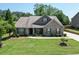 Beautiful home showcasing a lush green lawn, mature landscaping, and a welcoming front facade at 2906 Jones Phillips Rd, Dacula, GA 30019