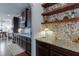 Kitchen counter with granite countertops, dark cabinets, and open shelving at 2906 Jones Phillips Rd, Dacula, GA 30019