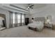 This main bedroom includes a ceiling fan, tray ceilings, and a sitting area at 2906 Jones Phillips Rd, Dacula, GA 30019