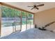 View of the screened in porch with ceiling fan, and access to the backyard with wooden fence at 2906 Jones Phillips Rd, Dacula, GA 30019