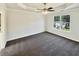 A spacious bedroom featuring plush carpet, a tray ceiling, and a large window for ample natural light at 3479 Woodruff Ridge Ln, Loganville, GA 30052