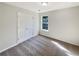 This bedroom has neutral paint, carpet, and ample light from the window and closet at 3479 Woodruff Ridge Ln, Loganville, GA 30052
