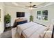 This cozy primary bedroom with a large window and a tray ceiling has been virtually staged at 3479 Woodruff Ridge Ln, Loganville, GA 30052