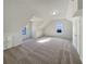 The large bonus room has plush carpeting and lots of natural light at 3479 Woodruff Ridge Ln, Loganville, GA 30052