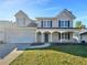 Charming two-story home with a well-manicured lawn, a two-car garage, and a welcoming front porch at 3479 Woodruff Ridge Ln, Loganville, GA 30052