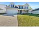 Charming two-story home with a well-manicured lawn, a two-car garage, and a welcoming front porch at 3479 Woodruff Ridge Ln, Loganville, GA 30052