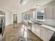 Bright eat-in kitchen boasts stainless appliances, granite countertops, tiled floor and lots of natural light at 3479 Woodruff Ridge Ln, Loganville, GA 30052