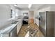 Bright kitchen with stainless steel appliances, white cabinetry, stone countertops, and decorative tile flooring at 3479 Woodruff Ridge Ln, Loganville, GA 30052