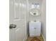 Small powder room features a vanity sink with a mirror and modern fixtures at 3479 Woodruff Ridge Ln, Loganville, GA 30052