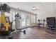 Basement gym area with vintage arcade games, french doors, and modern fitness equipment at 3725 Falls Trl, Winston, GA 30187
