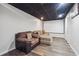 Finished basement with dark ceiling, projector screen, and comfortable seating area at 3725 Falls Trl, Winston, GA 30187
