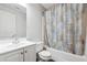 Clean bathroom features a white sink vanity, toilet, and shower-tub combo with a patterned curtain at 3725 Falls Trl, Winston, GA 30187