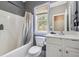 Well-lit bathroom with a shower-tub combo, vanity with white cabinets, and modern fixtures at 3725 Falls Trl, Winston, GA 30187