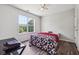 Bright bedroom with hardwood floors, large window with backyard views, and a modern ceiling fan at 3725 Falls Trl, Winston, GA 30187