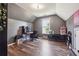 Spacious bedroom with a window, wood flooring, and ample space for an office setup or storage at 3725 Falls Trl, Winston, GA 30187