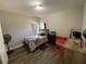 Bedroom with wood floors, neutral walls, ample natural light, and basic furnishings at 3725 Falls Trl, Winston, GA 30187