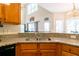 View of the kitchen featuring granite countertops, stainless sink, and high ceilings at 3725 Falls Trl, Winston, GA 30187