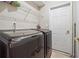 Convenient laundry room featuring modern washer and dryer, with built in shelving at 3725 Falls Trl, Winston, GA 30187