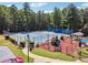 Aerial view of community tennis courts and playground with mature trees at 3725 Falls Trl, Winston, GA 30187