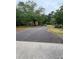 Long driveway leading to a single story home with lush green trees at 4897 Lou Ivy Rd, Peachtree Corners, GA 30096